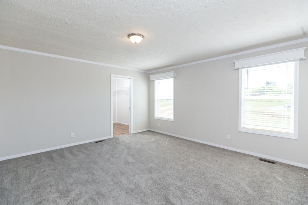 The REMINGTON Primary Bedroom. This Manufactured Mobile Home features 3 bedrooms and 2 baths.