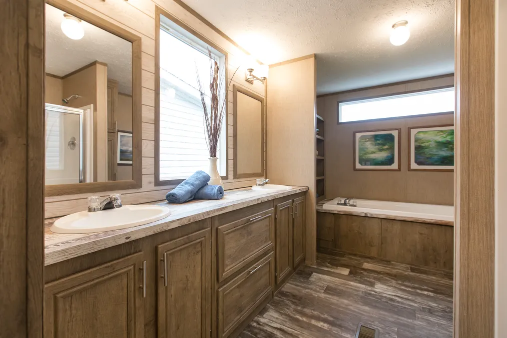 The THE CREEKWOOD Primary Bathroom. This Manufactured Mobile Home features 4 bedrooms and 2 baths.