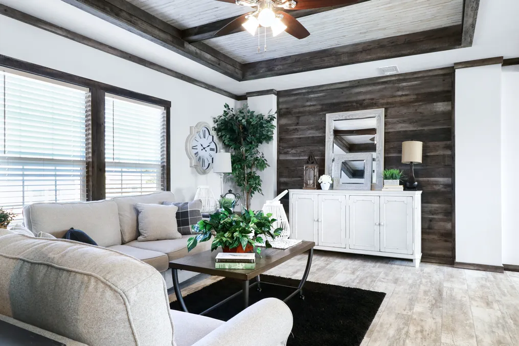 The THE COWBOY Living Room. This Manufactured Mobile Home features 3 bedrooms and 2 baths.