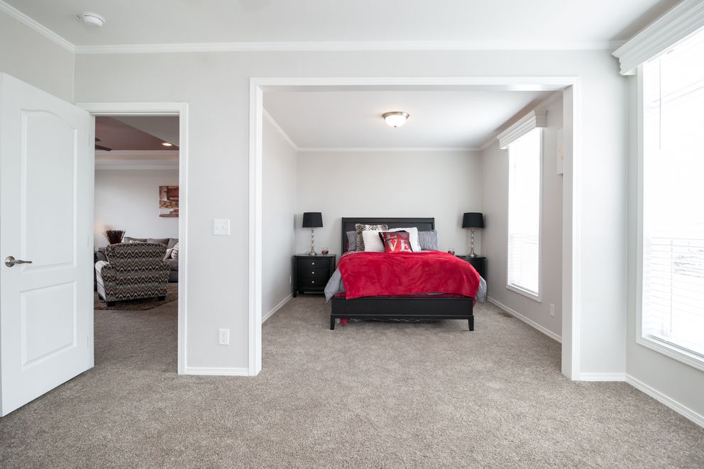 The ENCHANTMENT 3070A Primary Bedroom. This Manufactured Mobile Home features 3 bedrooms and 2 baths.