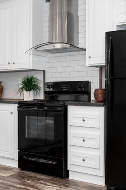 The THE SOCIAL 76 Kitchen. This Manufactured Mobile Home features 3 bedrooms and 2 baths.