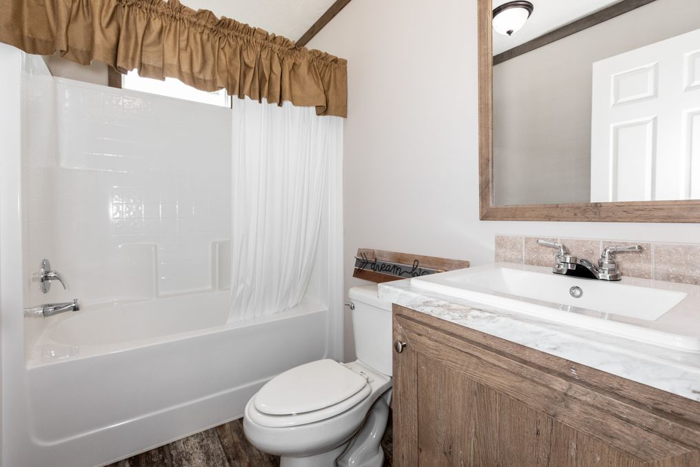 The THE WALSH Guest Bathroom. This Manufactured Mobile Home features 3 bedrooms and 2 baths.
