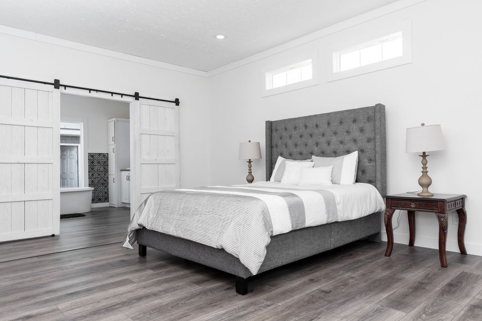 The 1440 CAROLINA 4BR BELLE Primary Bedroom. This Manufactured Mobile Home features 4 bedrooms and 2 baths.