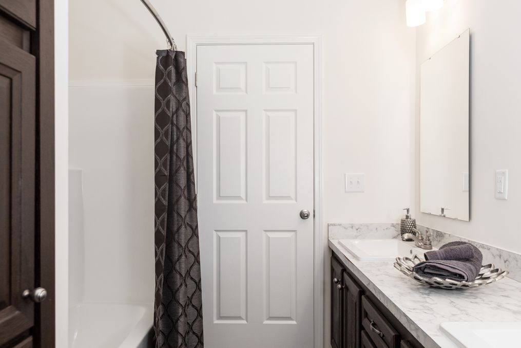 The 1444 CAROLINA Guest Bathroom. This Manufactured Mobile Home features 4 bedrooms and 2 baths.
