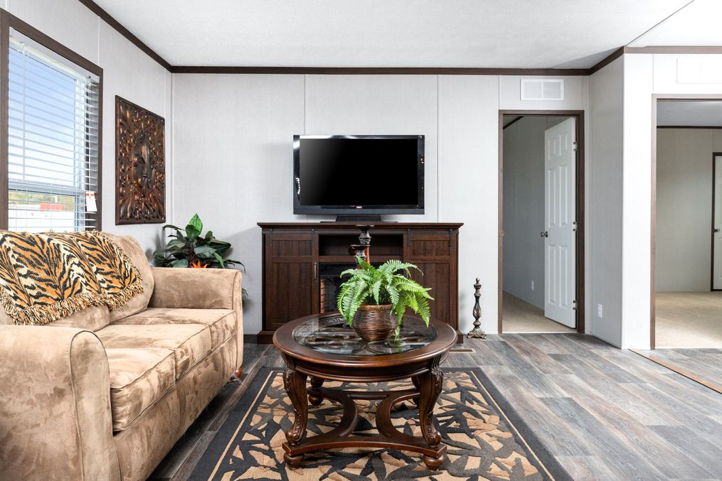 The THE CHOICE Living Room. This Manufactured Mobile Home features 4 bedrooms and 2 baths.