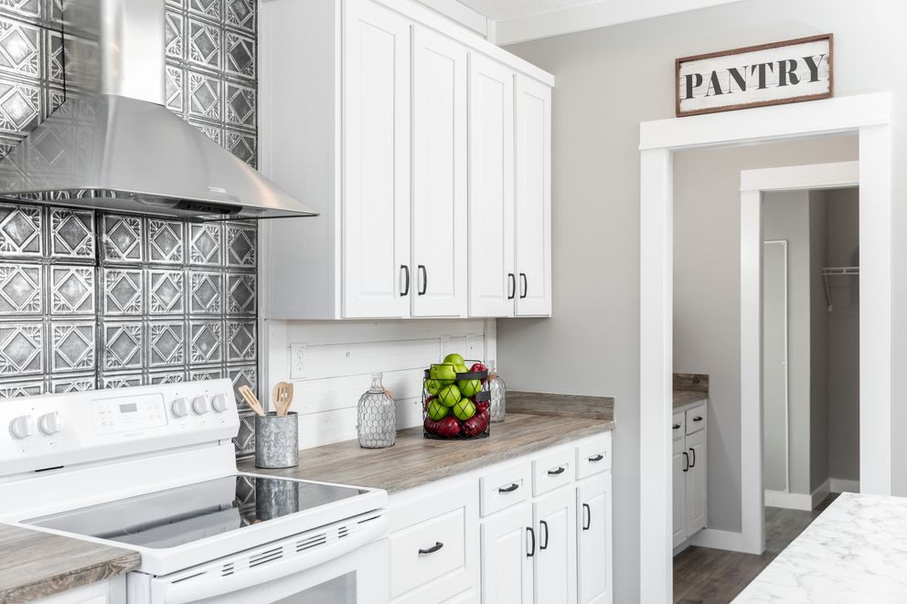 The 1440 CAROLINA 4BR BELLE Kitchen. This Manufactured Mobile Home features 4 bedrooms and 2 baths.