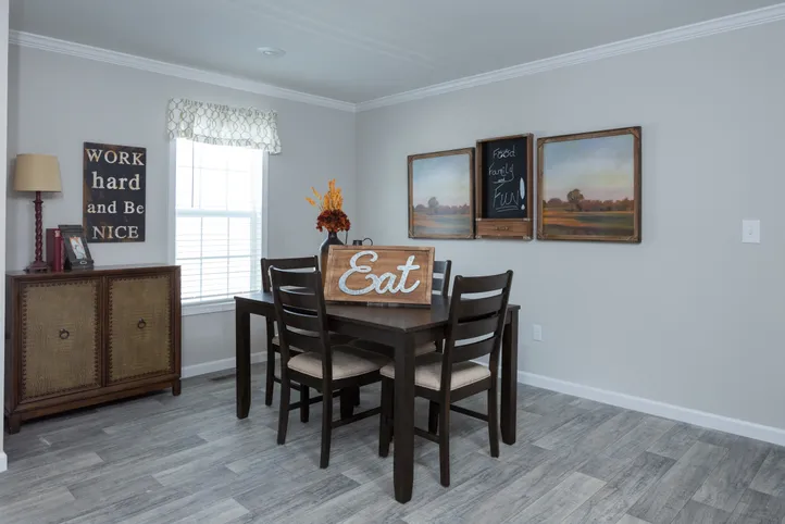 The THE FREEDOM BREEZE Dining Area. This Manufactured Mobile Home features 3 bedrooms and 2 baths.