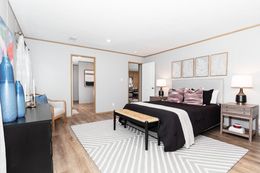 The SAFARI Primary Bedroom. This Manufactured Mobile Home features 3 bedrooms and 2 baths.