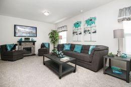 The HALLMARK PLUS Living Room. This Manufactured Mobile Home features 3 bedrooms and 3 baths.