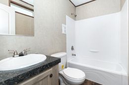The THE ANNIVERSARY 18 4 BR Guest Bathroom. This Manufactured Mobile Home features 4 bedrooms and 2 baths.