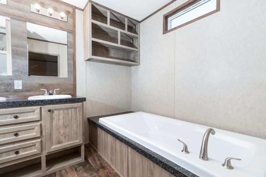 The THE ANNIVERSARY 18 4 BR Master Bathroom. This Manufactured Mobile Home features 4 bedrooms and 2 baths.