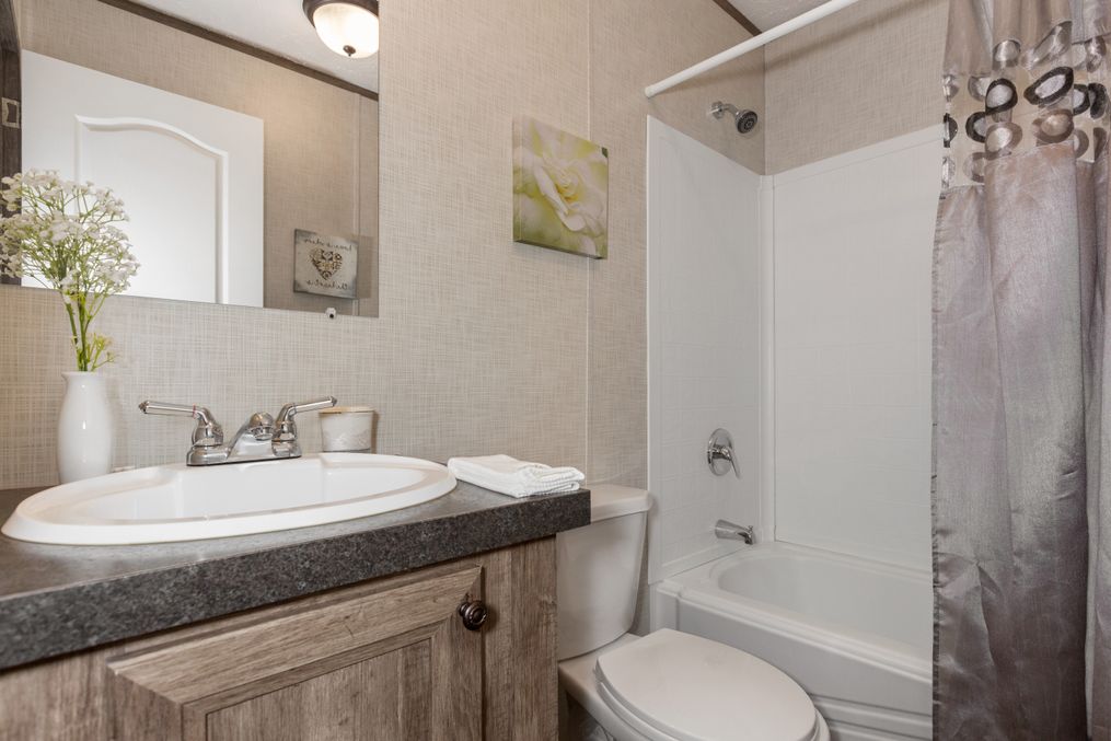 The THE ANNIVERSARY Guest Bathroom. This Manufactured Mobile Home features 3 bedrooms and 2 baths.