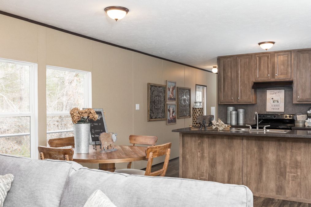 The THE SOLUTION Dining Area. This Manufactured Mobile Home features 3 bedrooms and 2 baths.