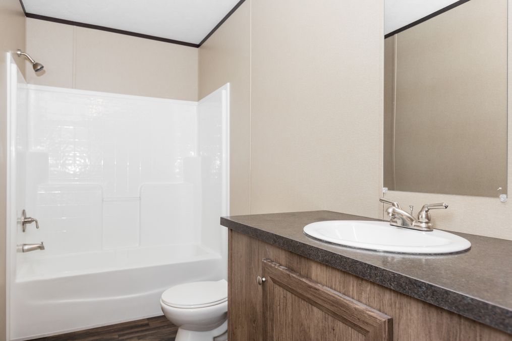 The THE SOLUTION Primary Bathroom. This Manufactured Mobile Home features 3 bedrooms and 2 baths.