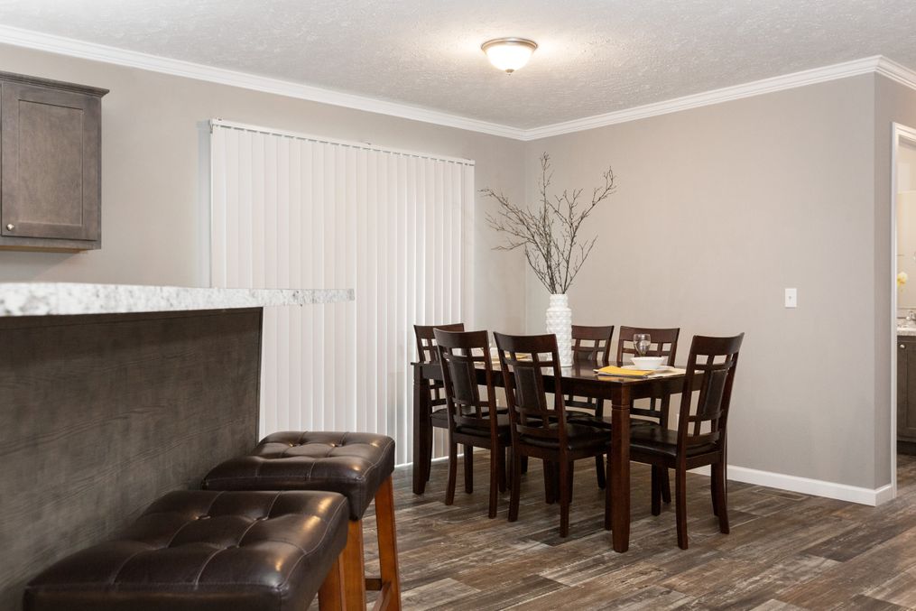 The TUCSON Dining Area. This Manufactured Mobile Home features 3 bedrooms and 2 baths.