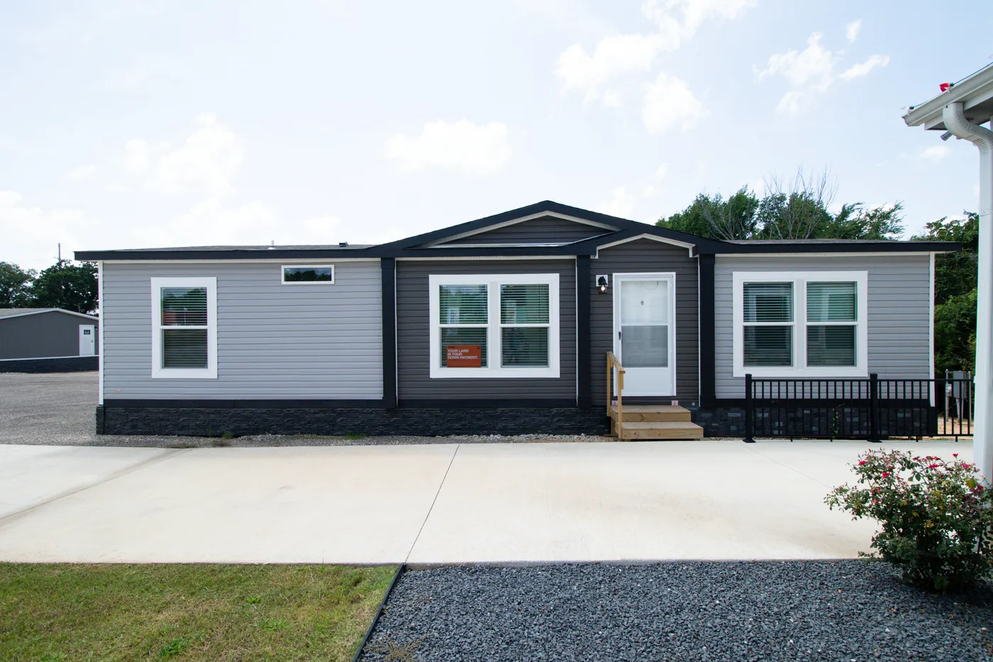 The THE REAL DEAL Exterior. This Manufactured Mobile Home features 3 bedrooms and 2 baths.