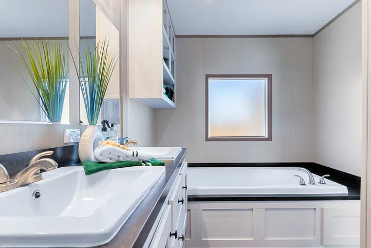 The ANNIVERSARY 16763I Primary Bathroom. This Manufactured Mobile Home features 3 bedrooms and 2 baths.