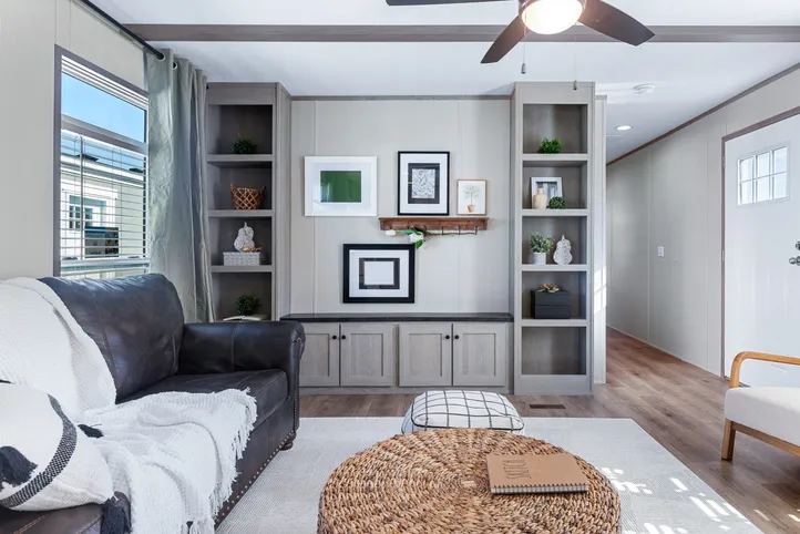 The ANNIVERSARY 16763I Living Room. This Manufactured Mobile Home features 3 bedrooms and 2 baths.