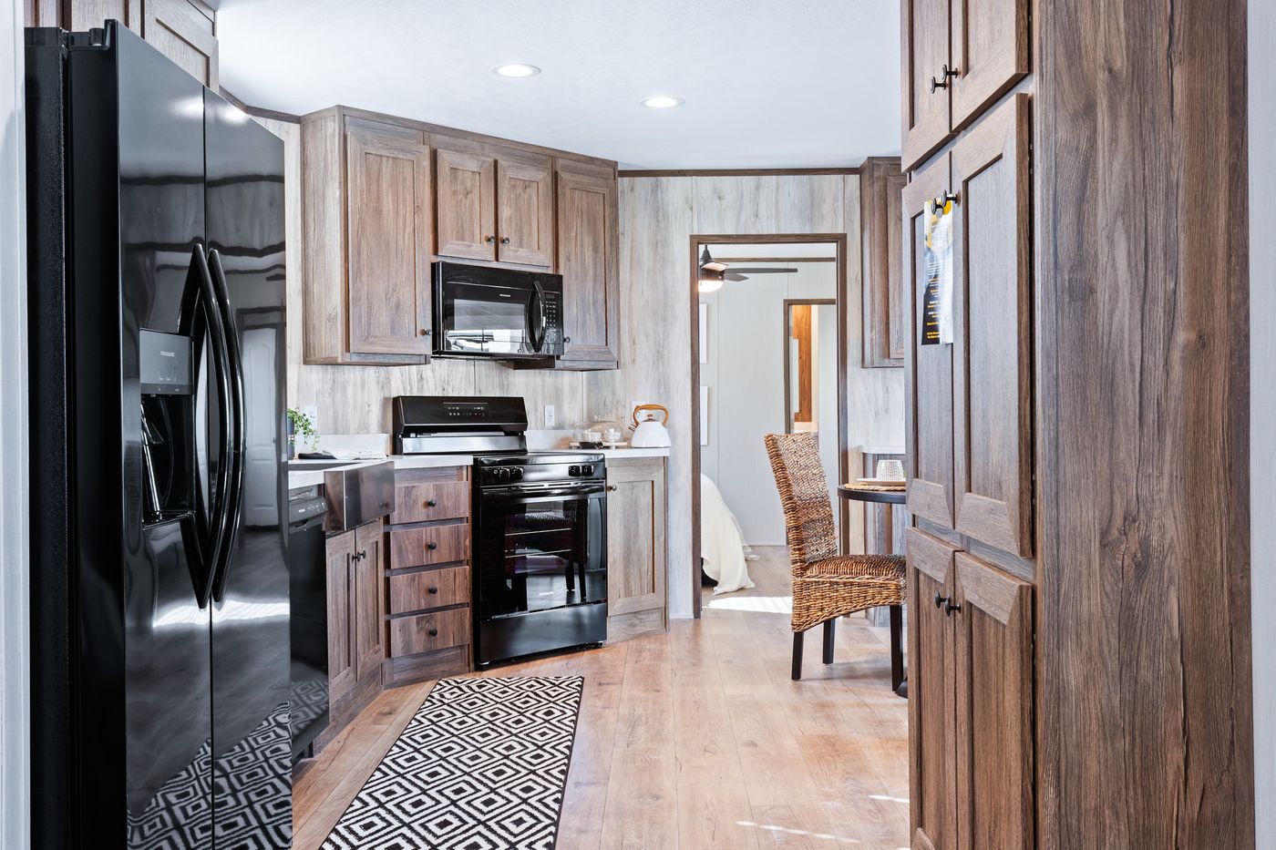 The ANNIVERSARY 16763F Kitchen. This Manufactured Mobile Home features 3 bedrooms and 2 baths.