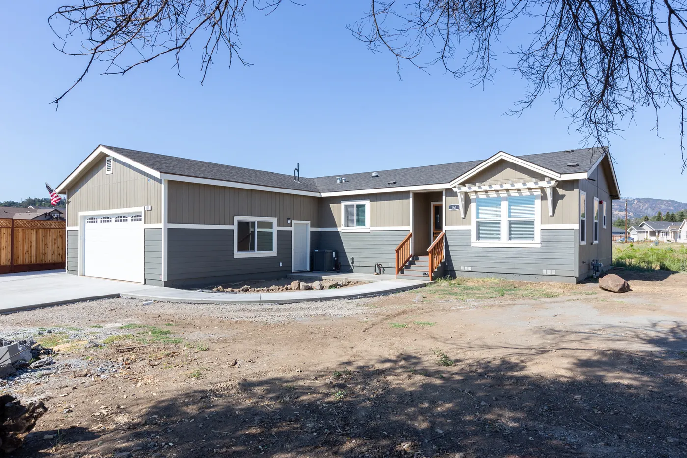 The CORONADO 24563C Trellis Exterior with Garage. This Manufactured Mobile Home features 3 bedrooms and 2 baths.