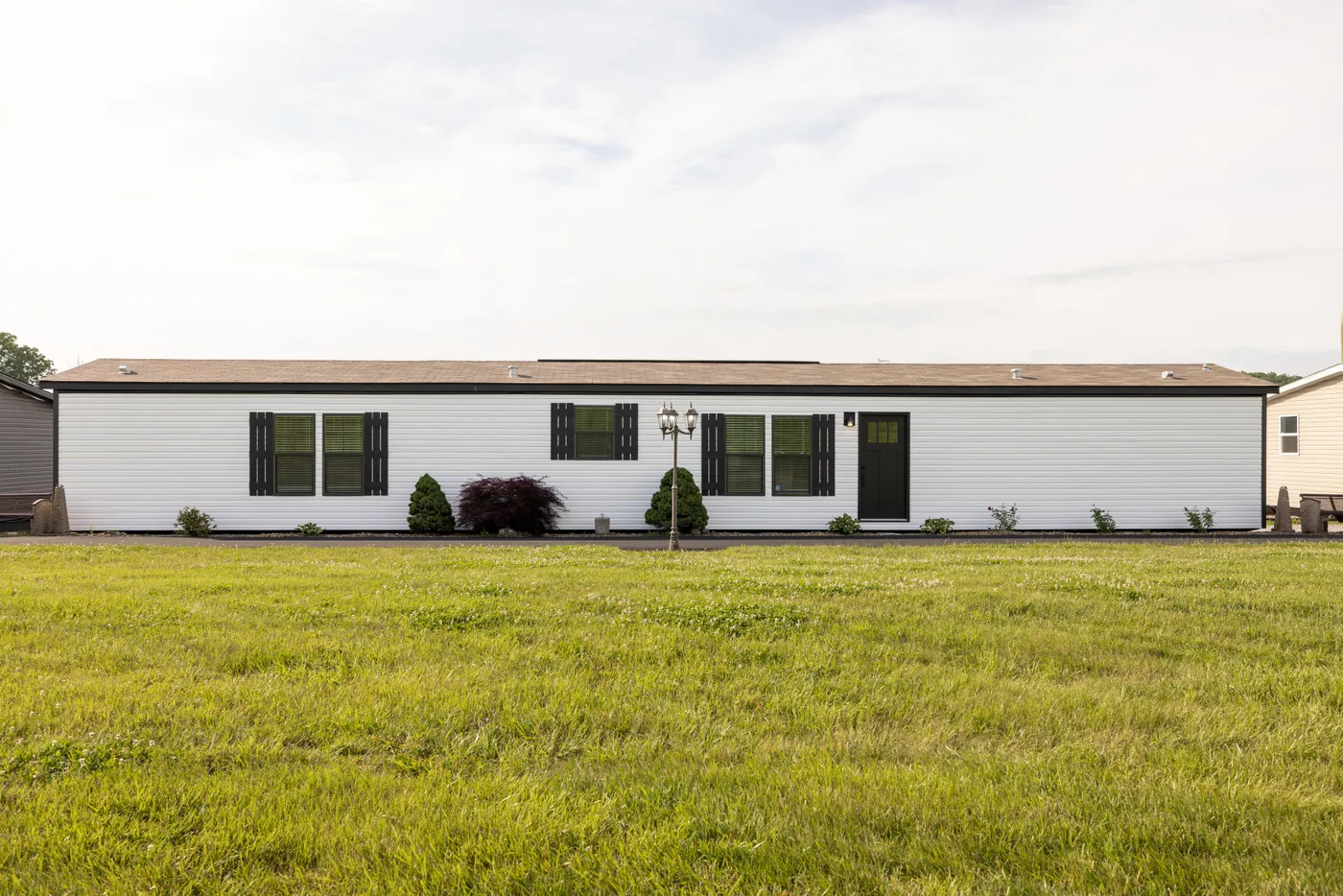 The SHOWER HOUSE Exterior. This Manufactured Mobile Home features 3 bedrooms and 2 baths.