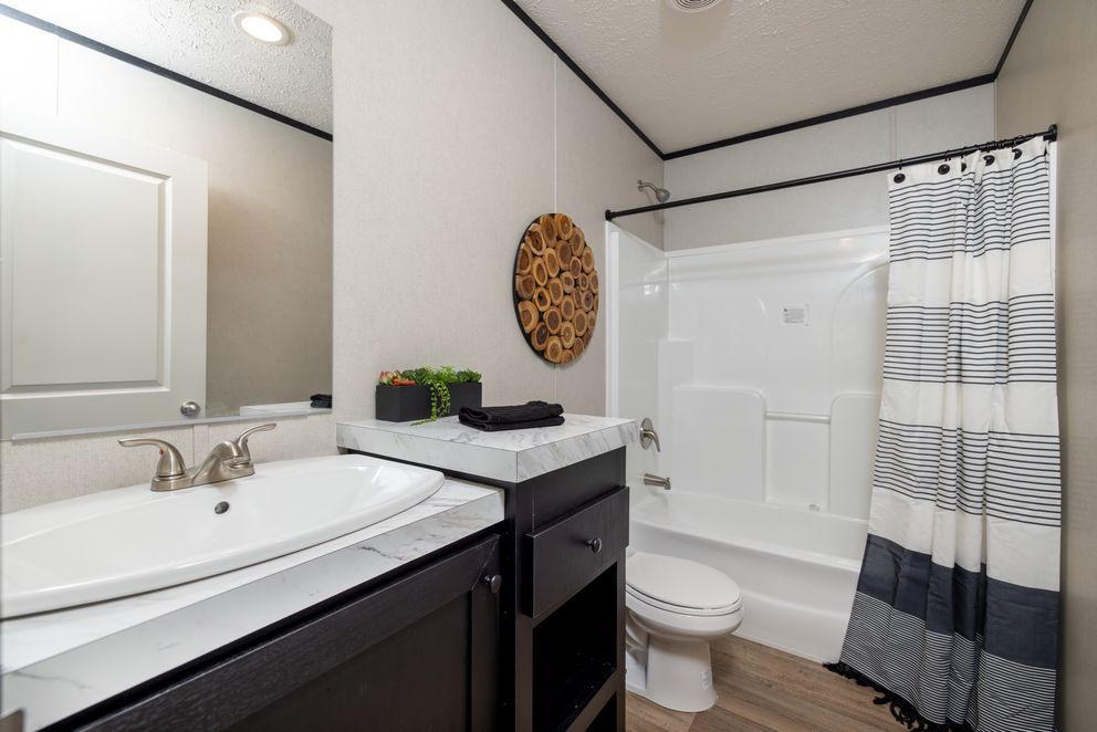 The PLATINUM ANNIVERSARY Exterior. This Manufactured Mobile Home features 3 bedrooms and 2 baths.