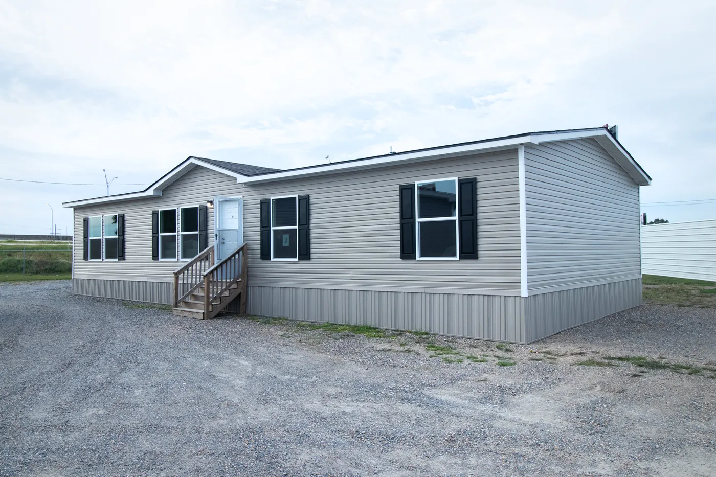 The ASPIRE Exterior. This Manufactured Mobile Home features 3 bedrooms and 2 baths.