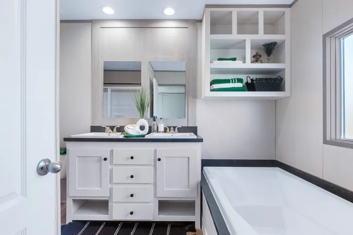 The ANNIVERSARY 16763I Guest Bathroom. This Manufactured Mobile Home features 3 bedrooms and 2 baths.