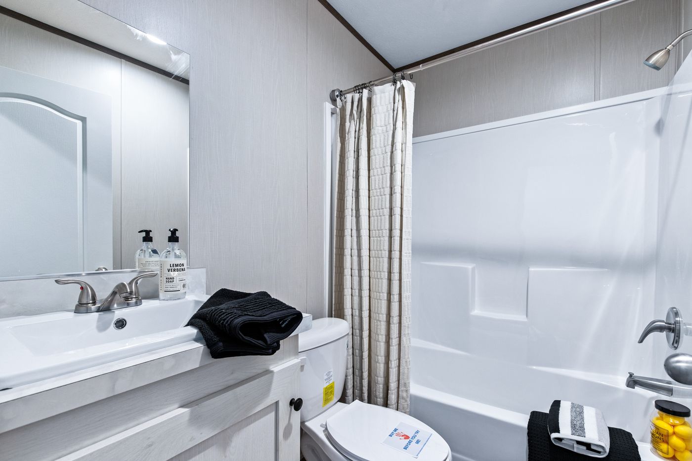 The ANNIVERSARY 16763F Guest Bathroom. This Manufactured Mobile Home features 3 bedrooms and 2 baths.