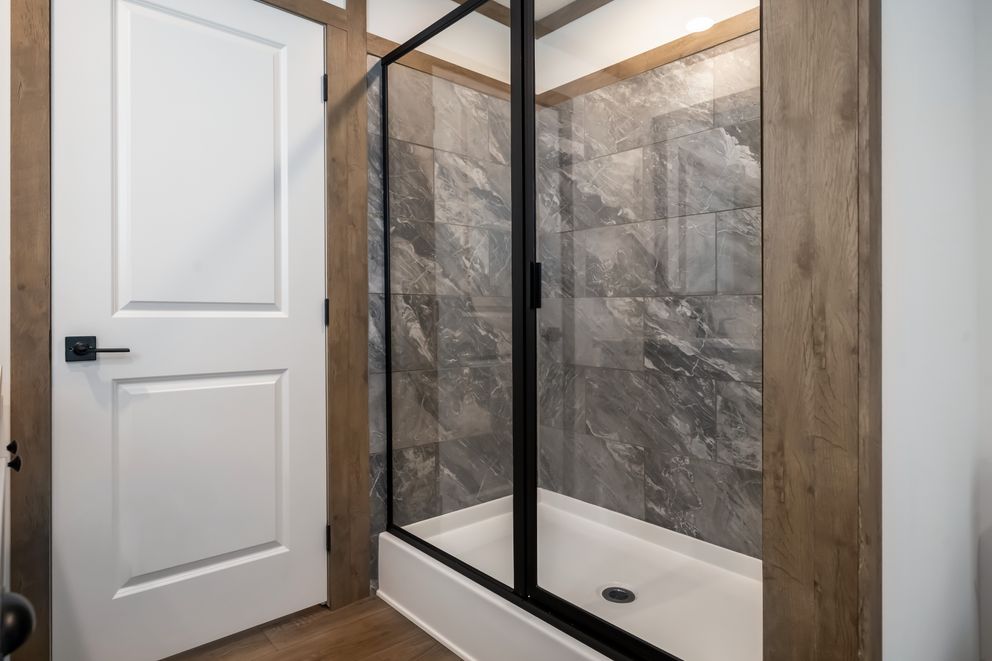 The THE LIZZIE Primary Bathroom. This Manufactured Mobile Home features 3 bedrooms and 2 baths.