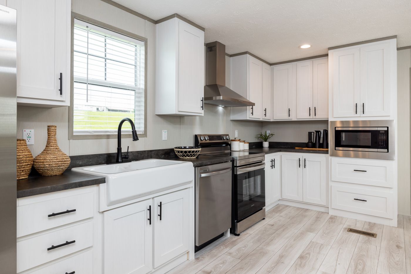 The SHOWER HOUSE Kitchen. This Manufactured Mobile Home features 3 bedrooms and 2 baths.