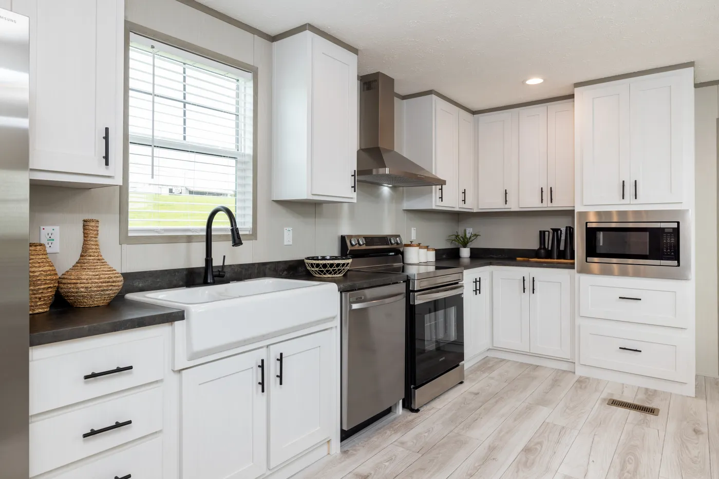 The SHOWER HOUSE Kitchen. This Manufactured Mobile Home features 3 bedrooms and 2 baths.