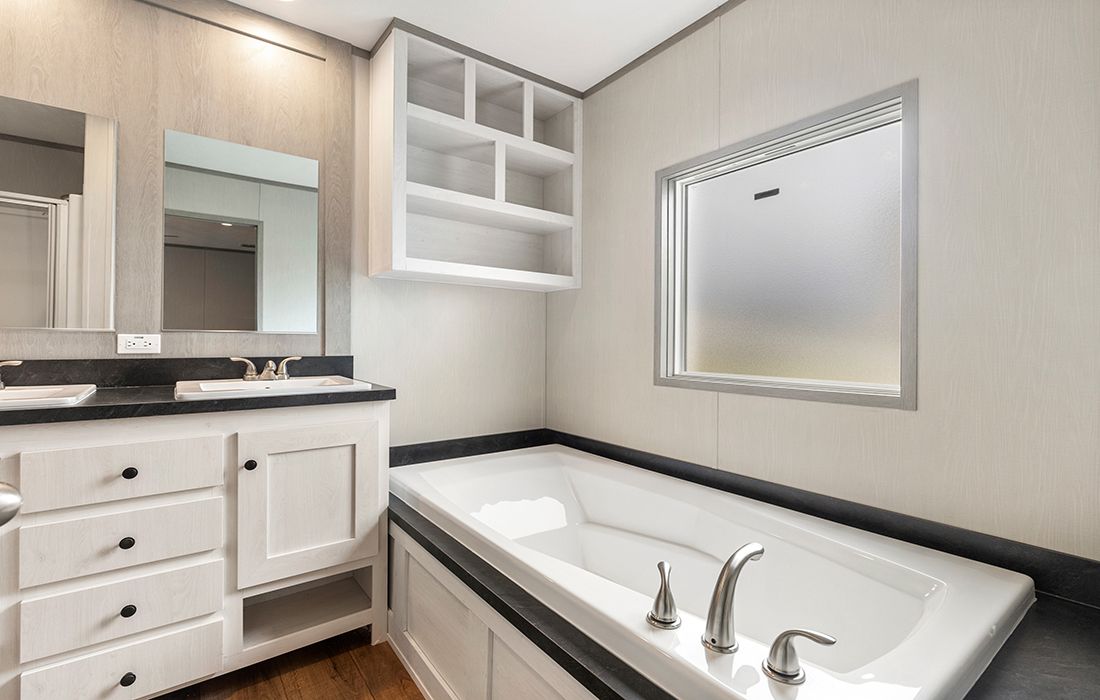 The PORCH LIVING SERIES 16682A Primary Bathroom. This Manufactured Mobile Home features 2 bedrooms and 2 baths.