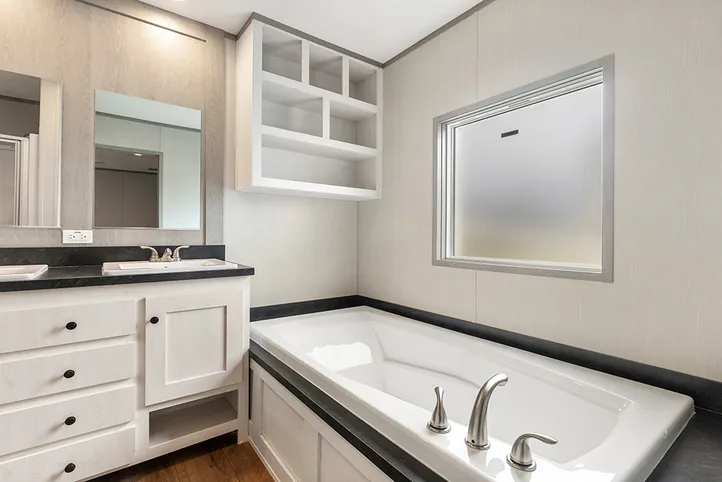 The PORCH LIVING SERIES 16682A Primary Bathroom. This Manufactured Mobile Home features 2 bedrooms and 2 baths.