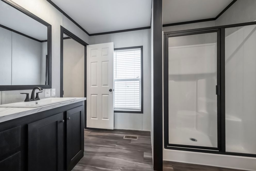 The LIL SOUTHERN CHARM Primary Bathroom. This Manufactured Mobile Home features 3 bedrooms and 2 baths.