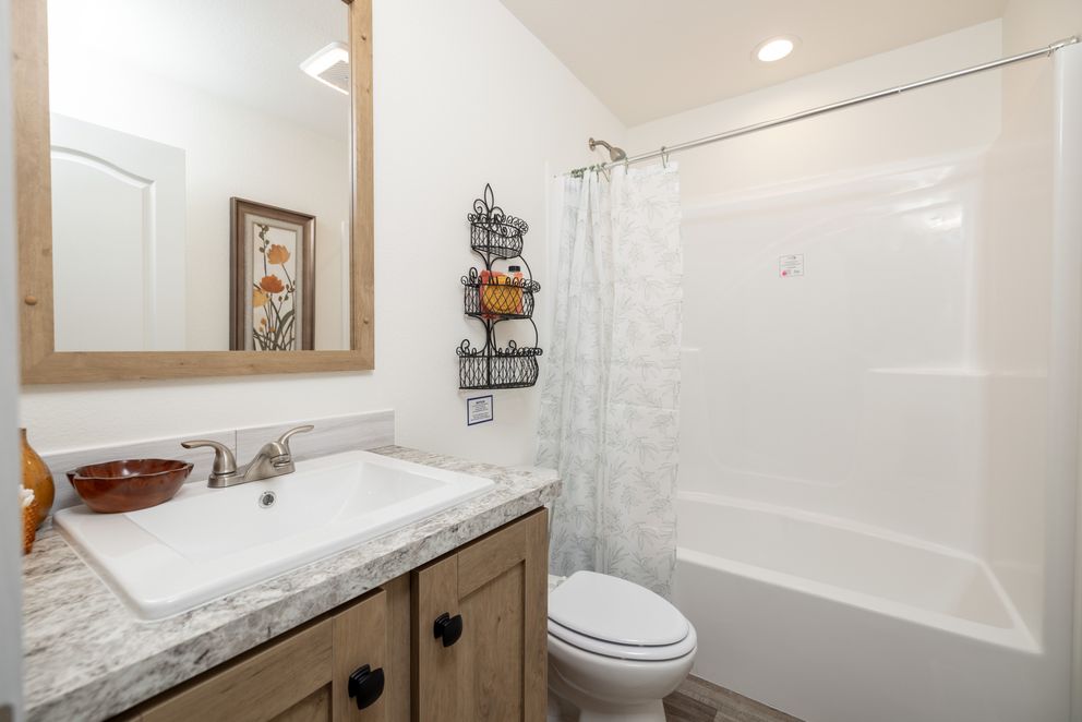 The JOHNNY B GOODE Guest Bathroom. This Manufactured Mobile Home features 3 bedrooms and 2 baths.