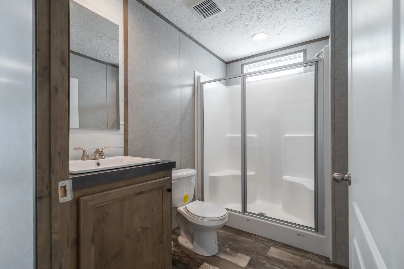 The LAKESIDE COTTAGE Guest Bathroom. This Manufactured Mobile Home features 1 bedroom and 1 bath.