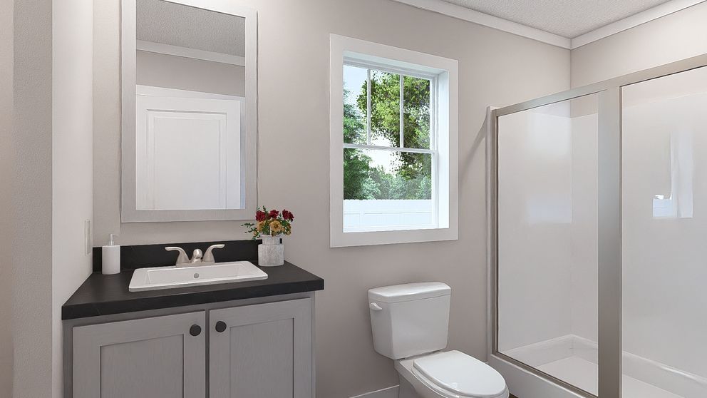 The MOVE ON UP Primary Bathroom. This Manufactured Mobile Home features 3 bedrooms and 2 baths.