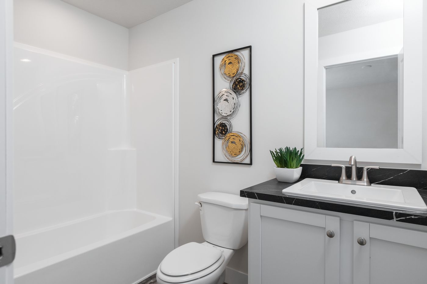 The 7616-SW018 SUNRISE SW Primary Bathroom. This Manufactured Mobile Home features 3 bedrooms and 2 baths.