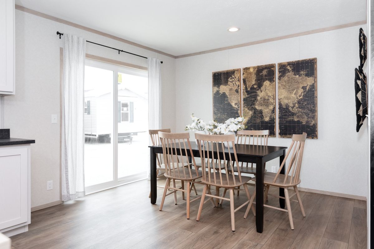 The 6032-5700 THE PULSE Dining Room. This Manufactured Mobile Home features 3 bedrooms and 2 baths.