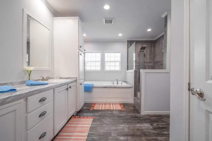 The THE HEWITT Primary Bathroom. This Manufactured Mobile Home features 4 bedrooms and 3 baths.
