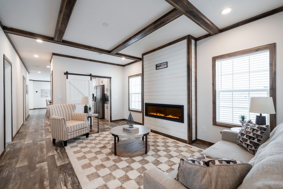 The 3237 THE TYBEE HUD Living Room. This Manufactured Mobile Home features 4 bedrooms and 3 baths.