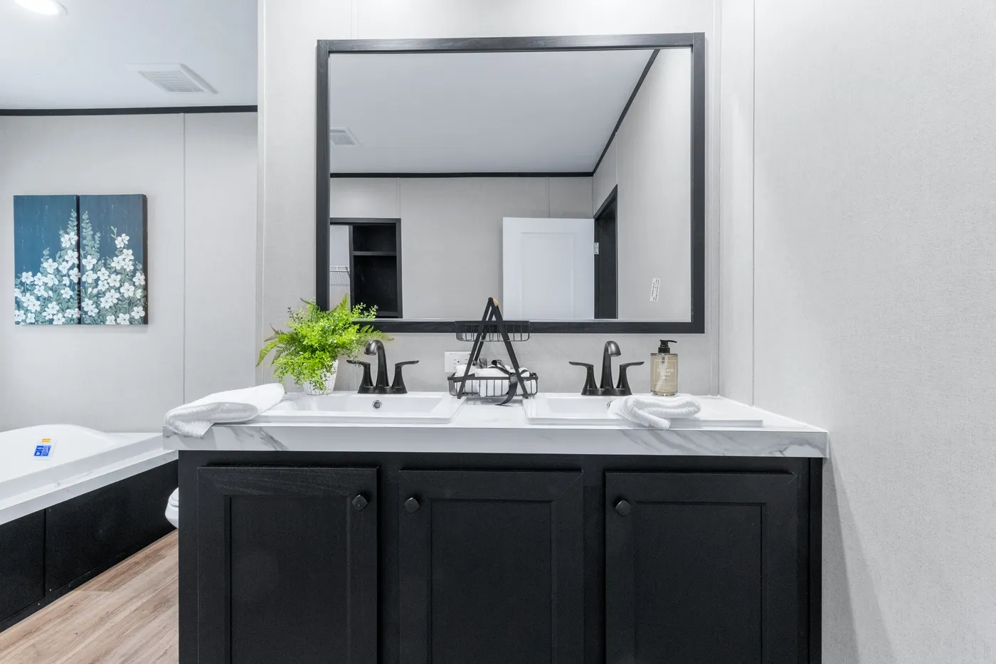 The ABSOLUTE VALUE Primary Bathroom. This Manufactured Mobile Home features 4 bedrooms and 2 baths.
