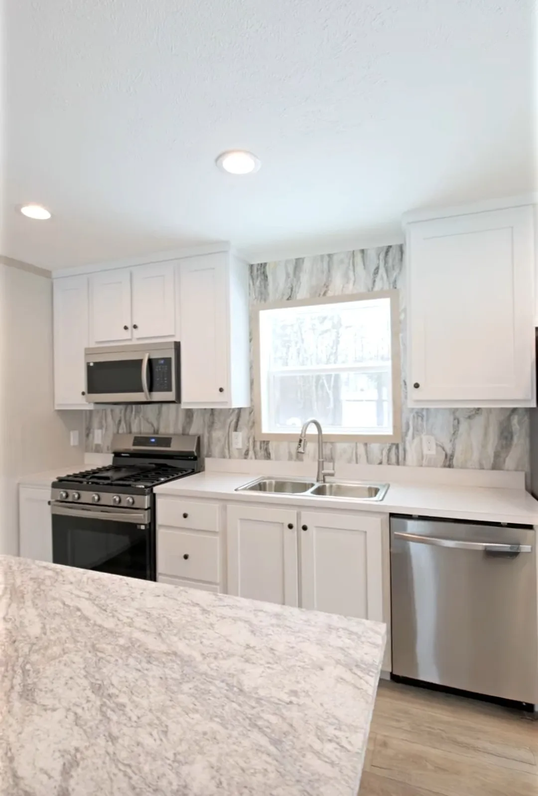 The TURQUOISE Kitchen. This Manufactured Mobile Home features 2 bedrooms and 2 baths.