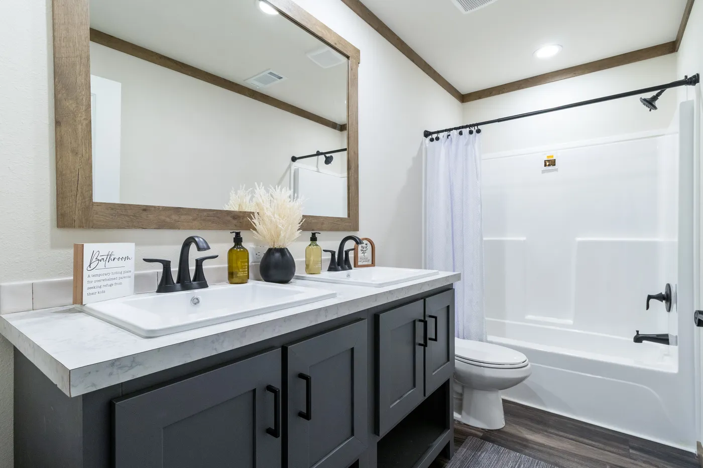 The EVERETT ELITE Primary Bathroom. This Manufactured Mobile Home features 4 bedrooms and 3 baths.