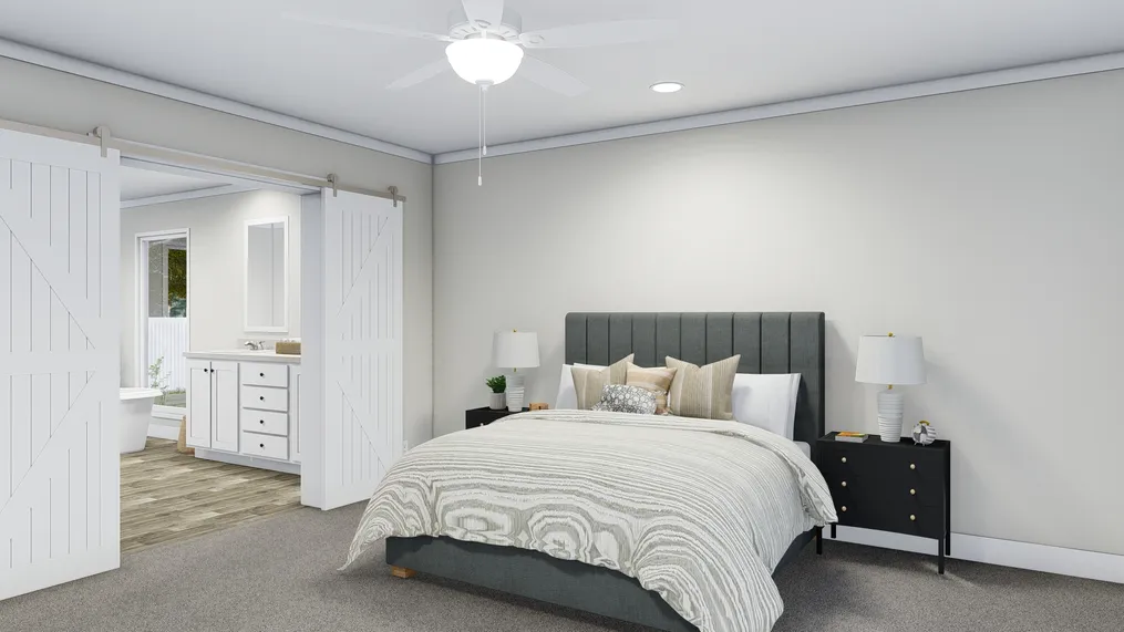 The COUNTRY AIRE Primary Bedroom. This Manufactured Mobile Home features 3 bedrooms and 3 baths.