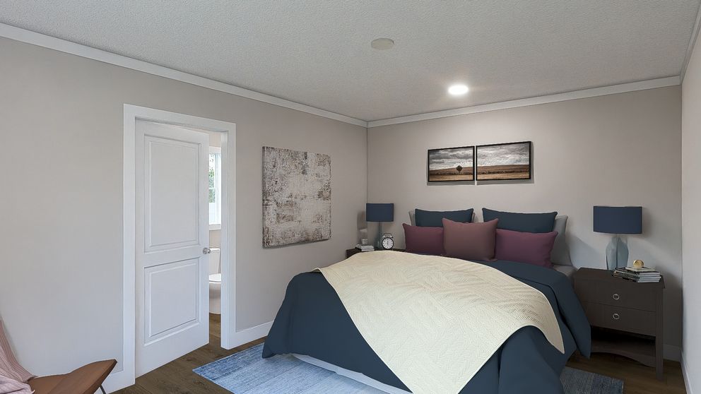 The MOVE ON UP Primary Bedroom. This Manufactured Mobile Home features 3 bedrooms and 2 baths.