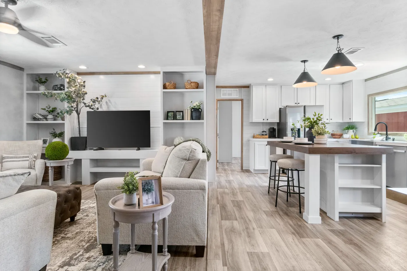 The THE REAL DEAL Living Room. This Manufactured Mobile Home features 3 bedrooms and 2 baths.