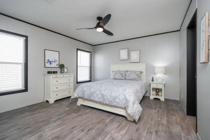 The BREEZE FARMHOUSE Primary Bedroom. This Manufactured Mobile Home features 3 bedrooms and 2 baths.
