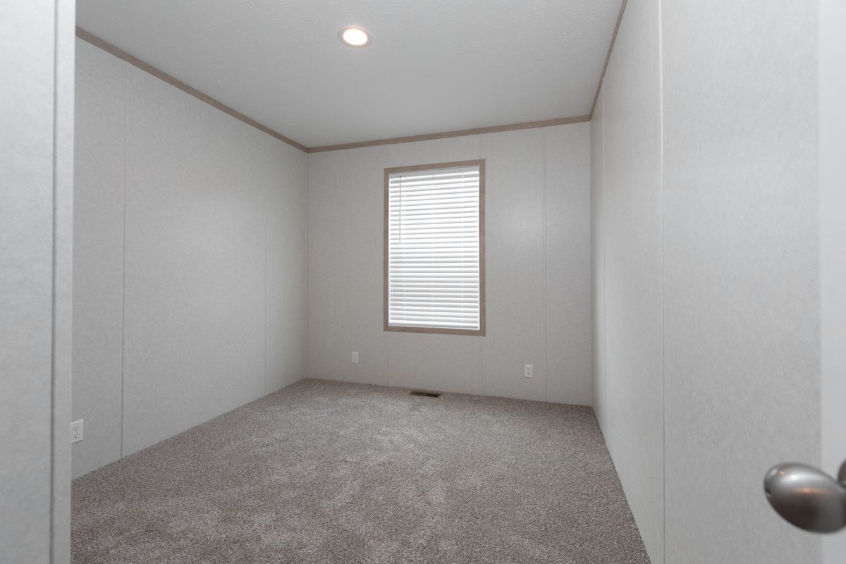 The 5628-5202 ADRENALINE Guest Bedroom. This Manufactured Mobile Home features 3 bedrooms and 2 baths.